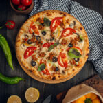 mix pizza with tomato slices, mushroom, olive, basil leaves, and minced meat